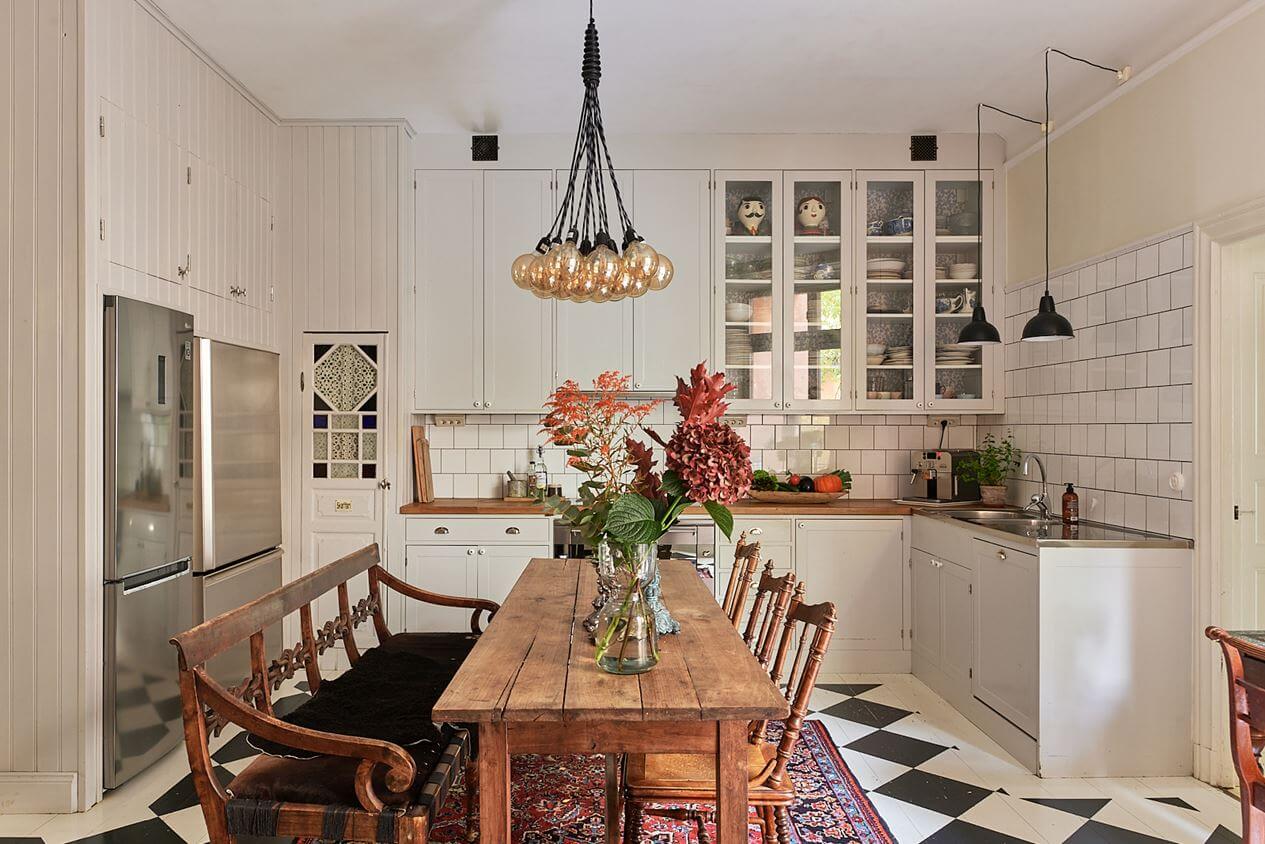 A Romantic Apartment with Original Details 18 kitchen-rustic-dining-table-checkerboard-floor