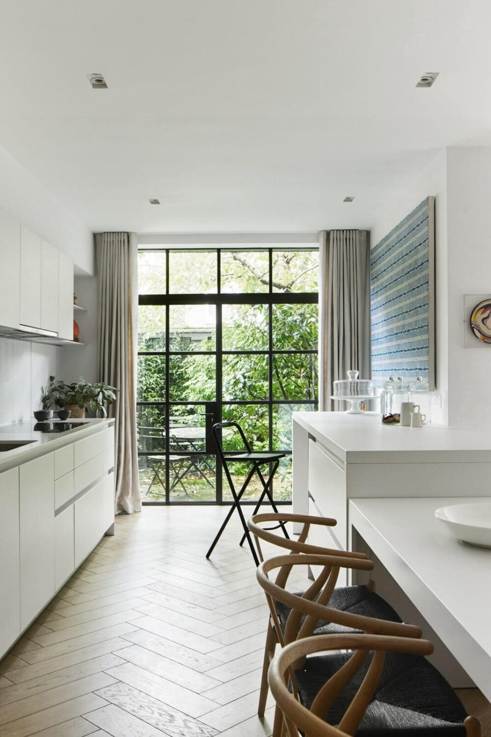 Stylish Monochrome Interiors in an Early 20th Century House 9 kitchen-white-cabinets-bar-seating-crittal-doors-garden