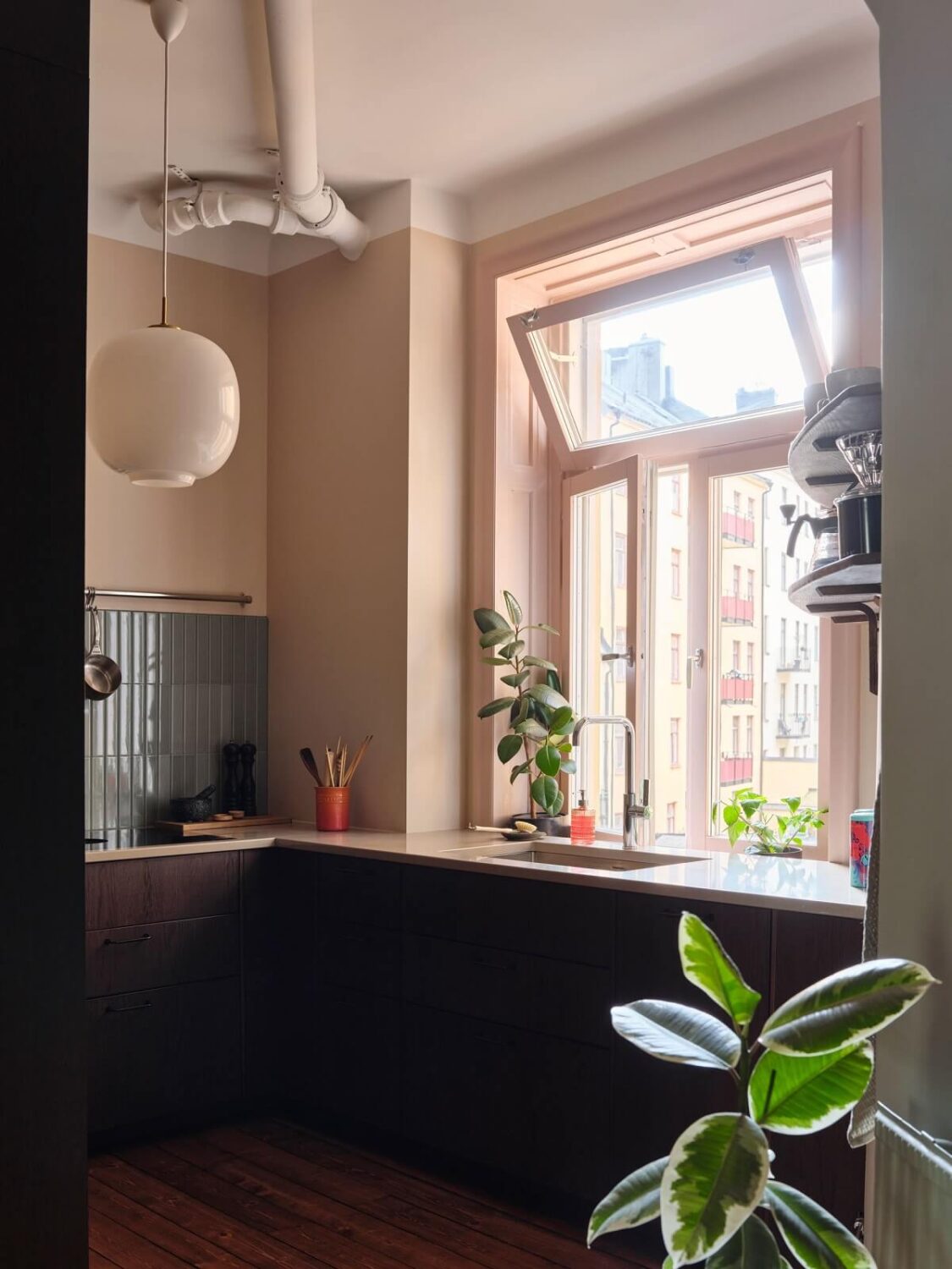 A Scandi Apartment Mixes Vintage with Contemporary Design 17 kitchen-wooden-cabinets-large-window-blue-tiles-nordroom