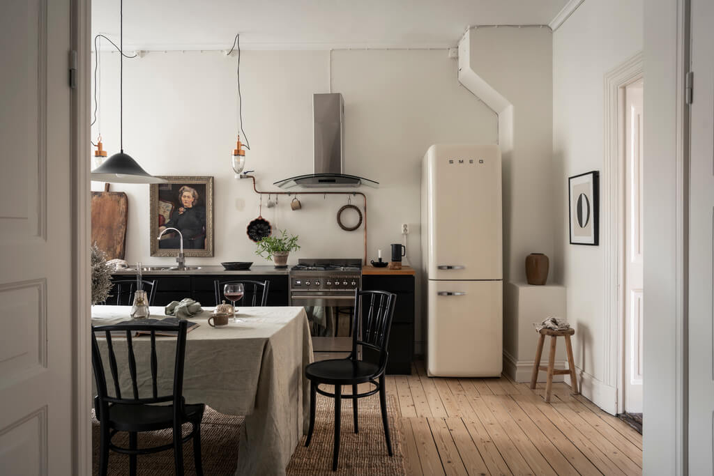 A Scandinavian Studio Apartment with Black Walls 15 kitchen wooden floor black cabinets