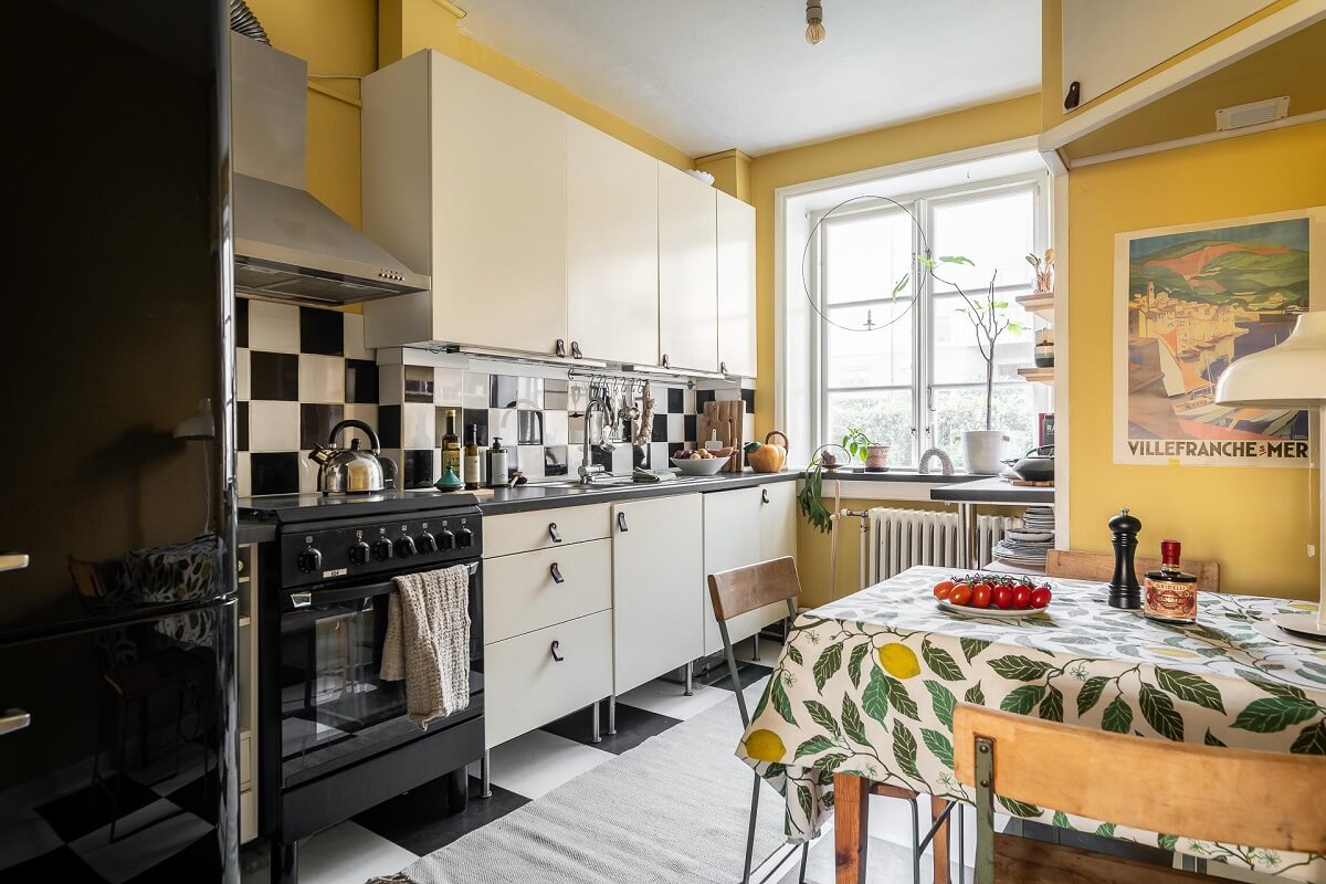 Colorful Decor in a Scandinavian Apartment 19 kitchen yellow walls checkerboard tiles