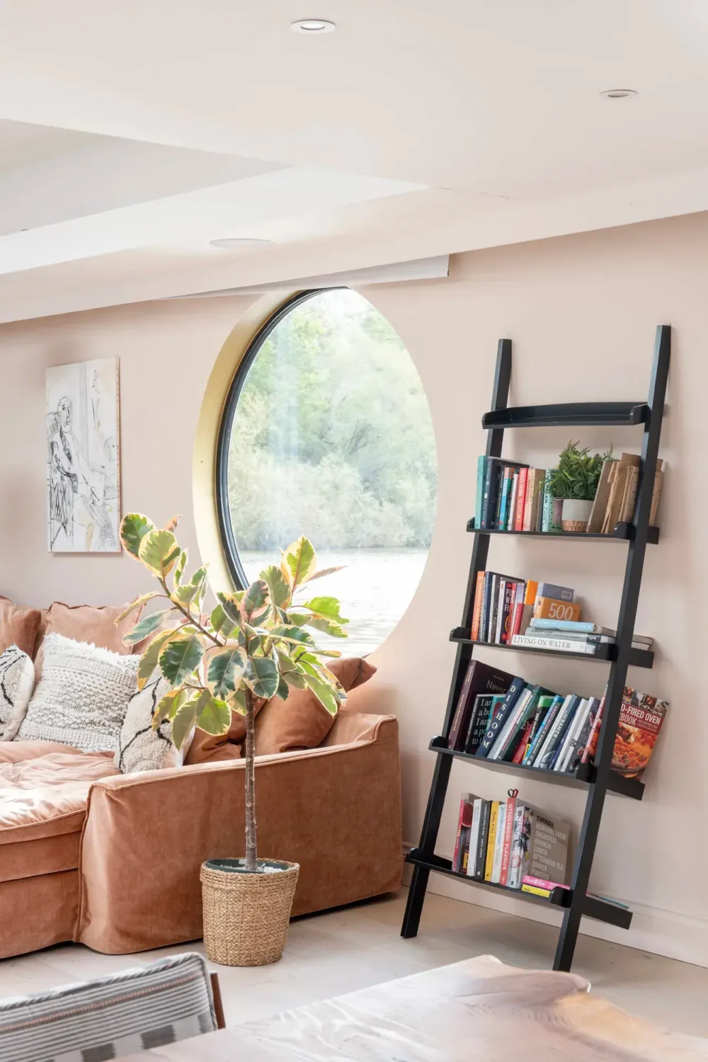 A Spacious and Stylish Houseboat in London 2 large round window living room houseboat nordroom