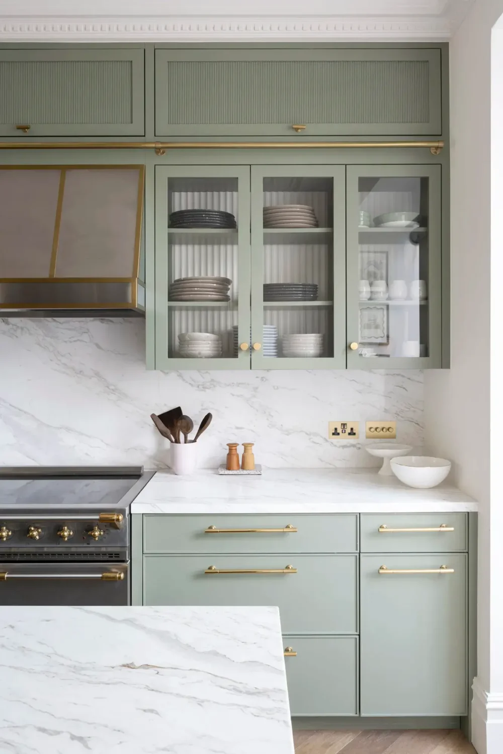 An Award-Winning Apartment with Color Accents in Notting Hill 8 light-green-kitchen-cabinets-brass-handles-notting-hill-nordroom