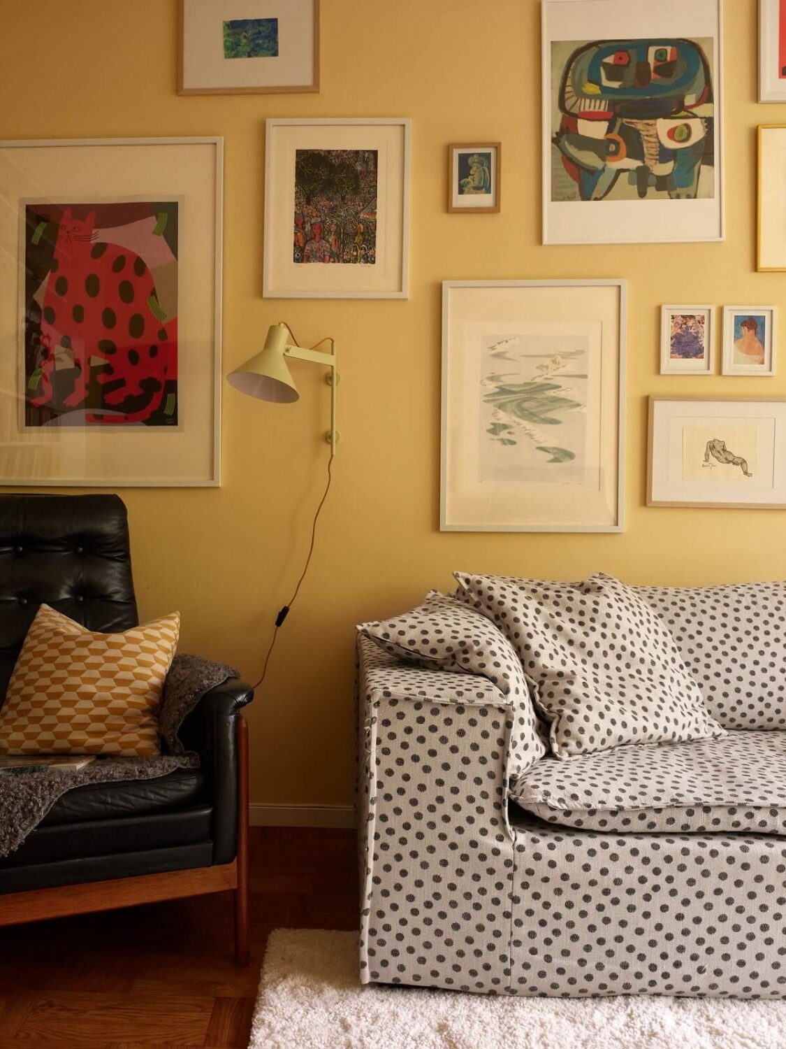 Soft Yellow Walls in a Swedish Apartment 6 living-room-accent-yellow-walls-polkadot-sofa