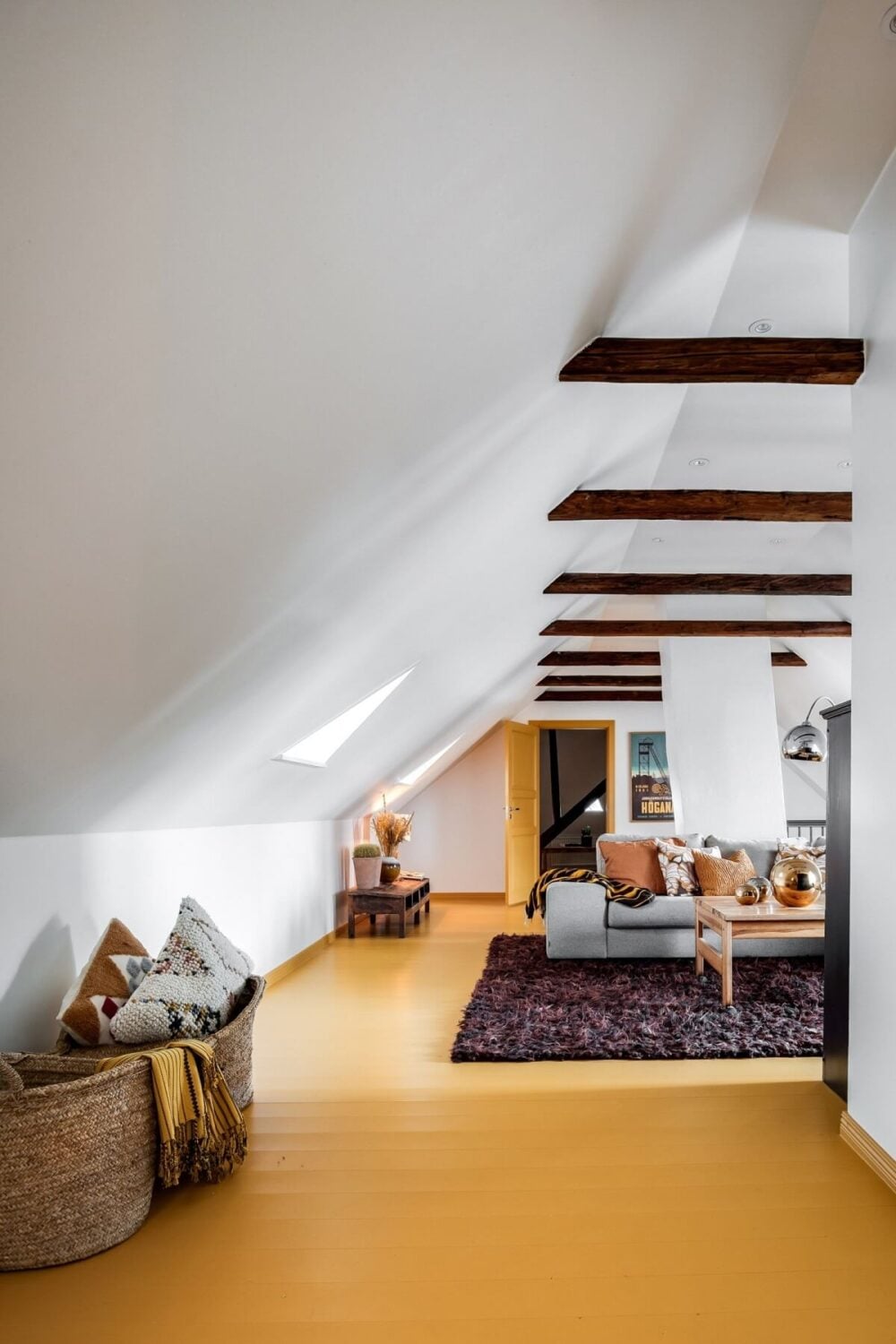 A Unique Bohemian Family Home in a Former Swedish Bakery 33 living-room-pitched-ceiling-wooden-beams-yellow-floorboards-nordroom