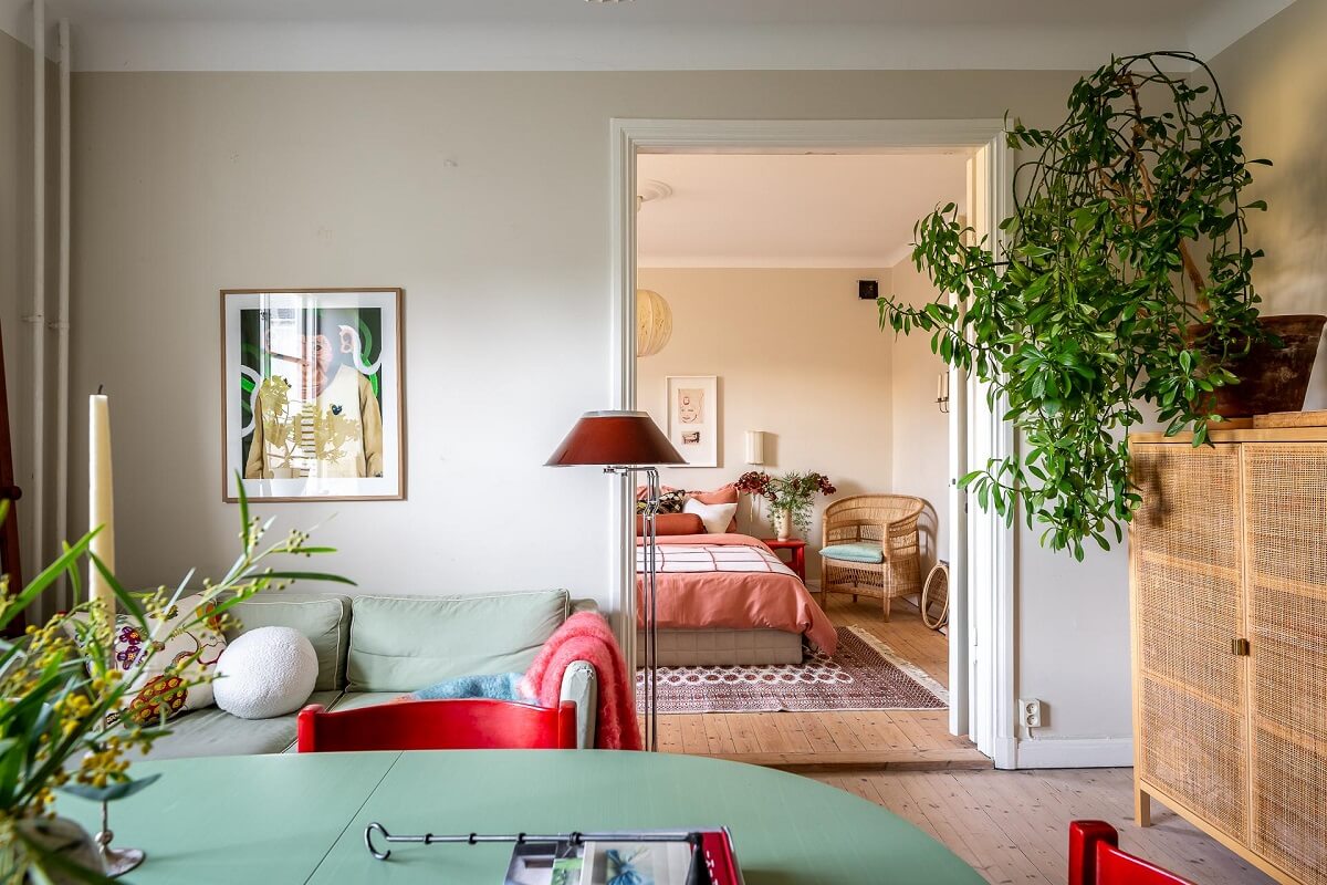 Colorful Decor in a Scandinavian Apartment 8 living-room-round-green-dining-table-hanging-plants