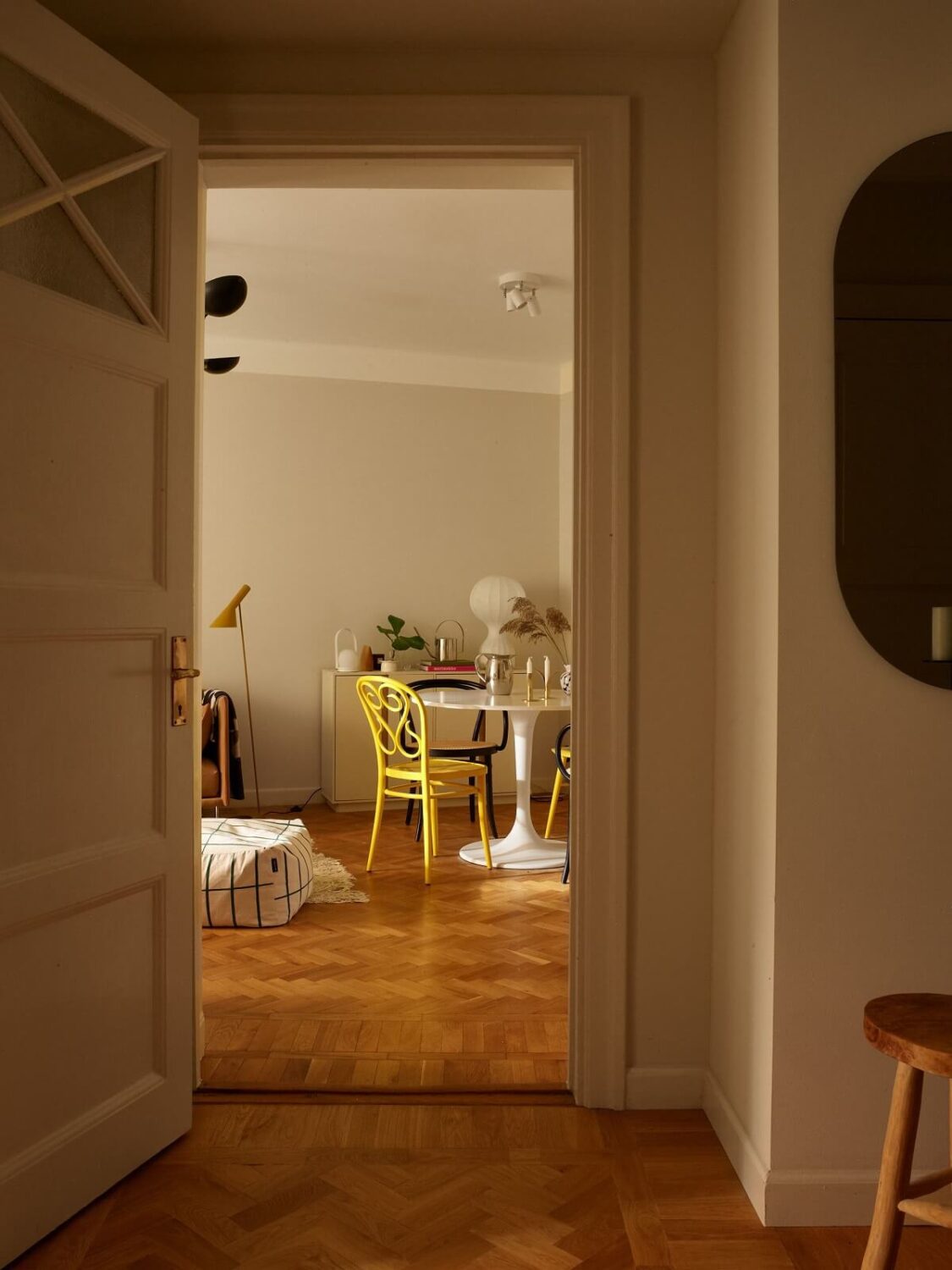 A Serene Light Colored Apartment with Bright Color Pops 5 living room view wooden floor