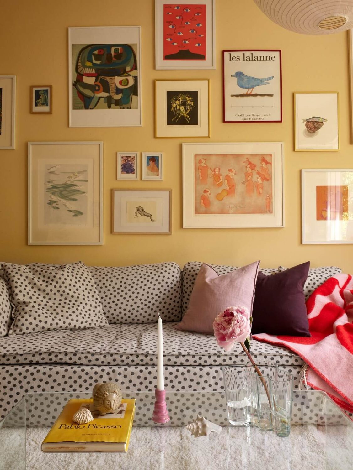 Soft Yellow Walls in a Swedish Apartment 2 living-room-yellow-walls-gallery-wall-polkadot-sofa-nordroom