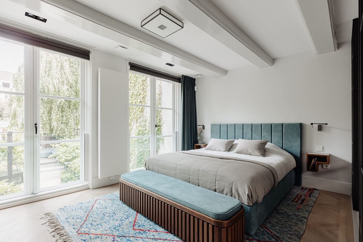 A Luxurious Amsterdam Canal House with High Ceilings 16 master bedroom amsterdam canal home blue headboard