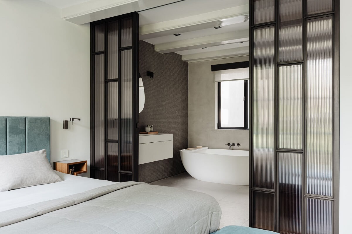 A Luxurious Amsterdam Canal House with High Ceilings 18 master bedroom blue headboard en suite bathroom steel walls