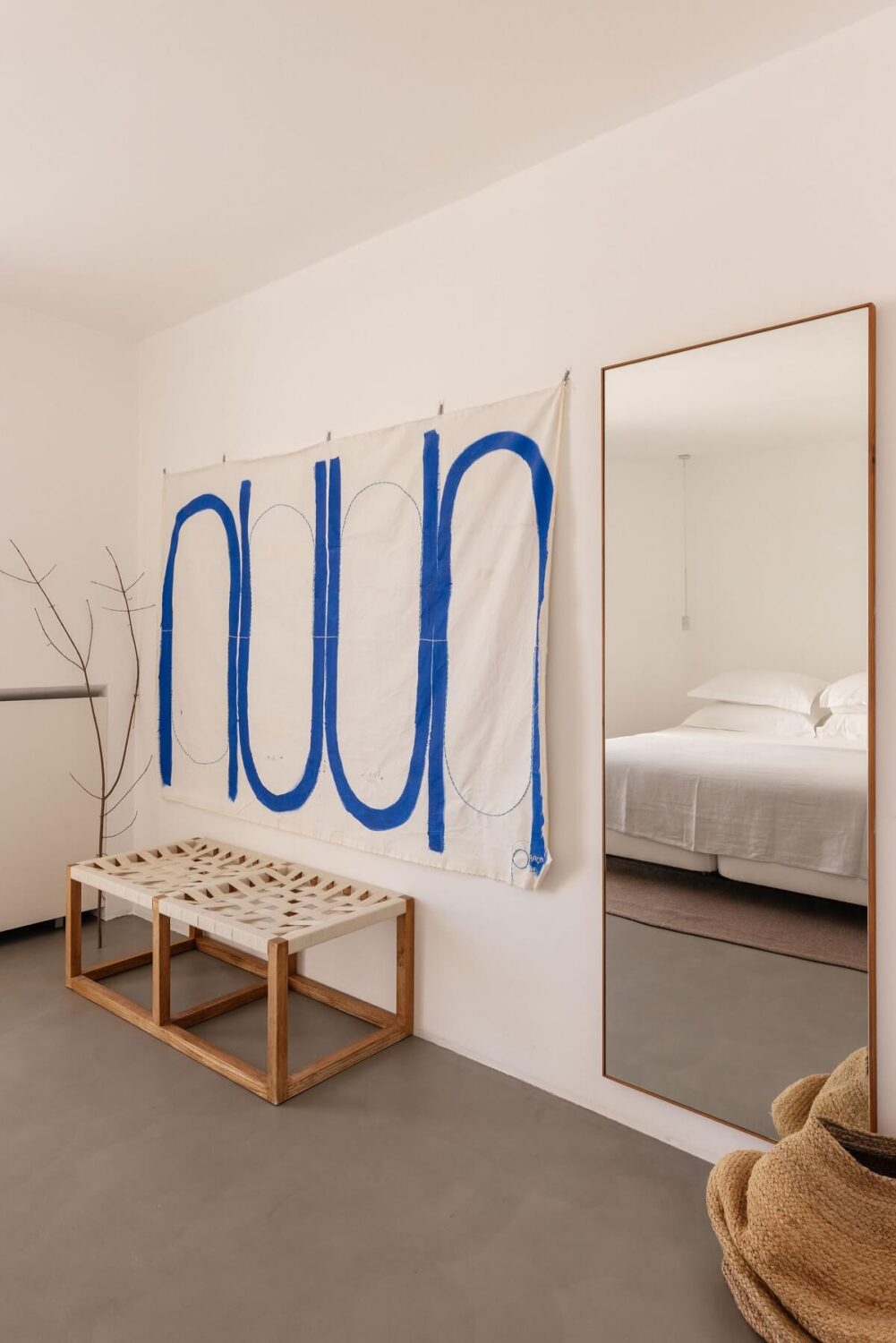 A Renovated 19th Century House with a Minimalistic Decor 10 minimalistic-bedroom-wall-hanging-mirror