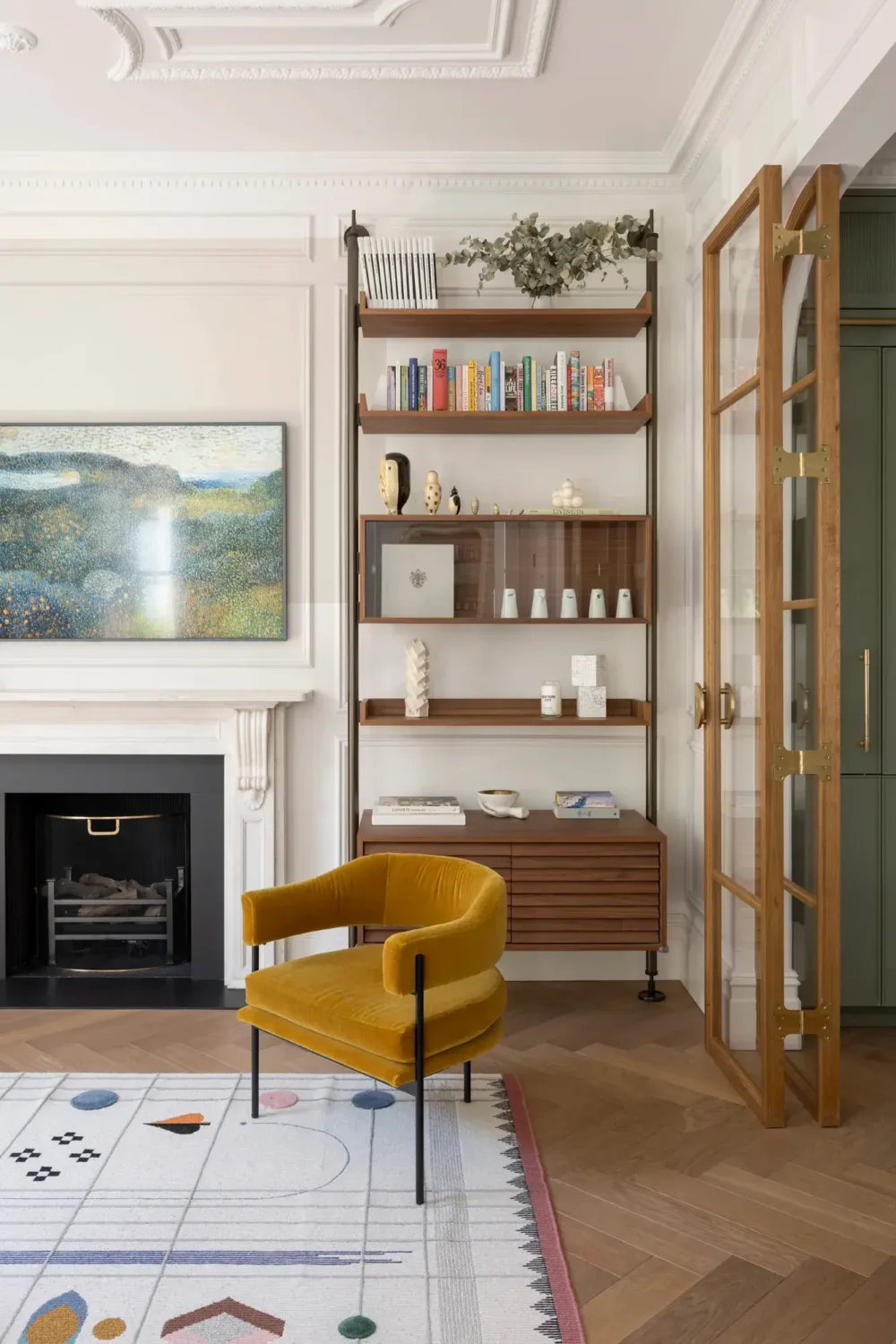 An Award-Winning Apartment with Color Accents in Notting Hill 5 ochre-chair-bookshelves-fireplace-nordroom
