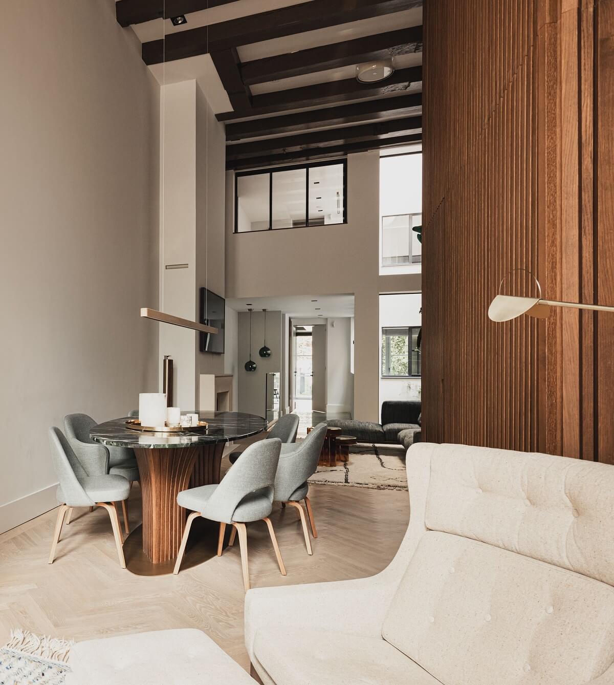 A Luxurious Amsterdam Canal House with High Ceilings 8 open plan living room double height ceiling dining space ceiling beams