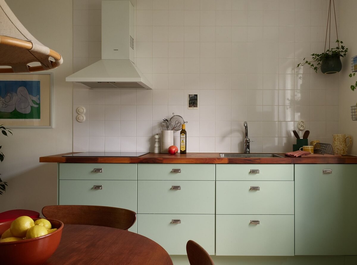 Soft Yellow Walls in a Swedish Apartment 12 pastel-green-kitchen-cabinets-nordroom