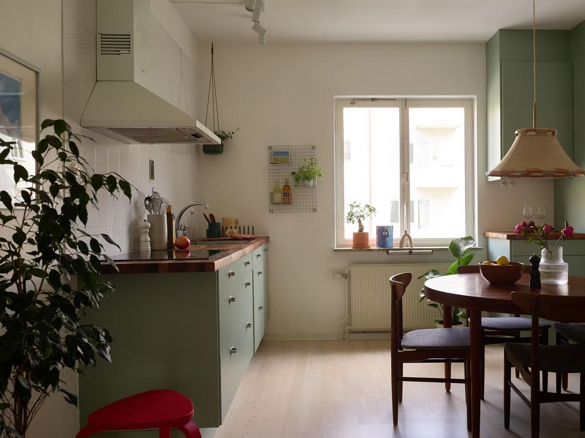 Soft Yellow Walls in a Swedish Apartment 9 pastel-green-kitchen-round-dining-table