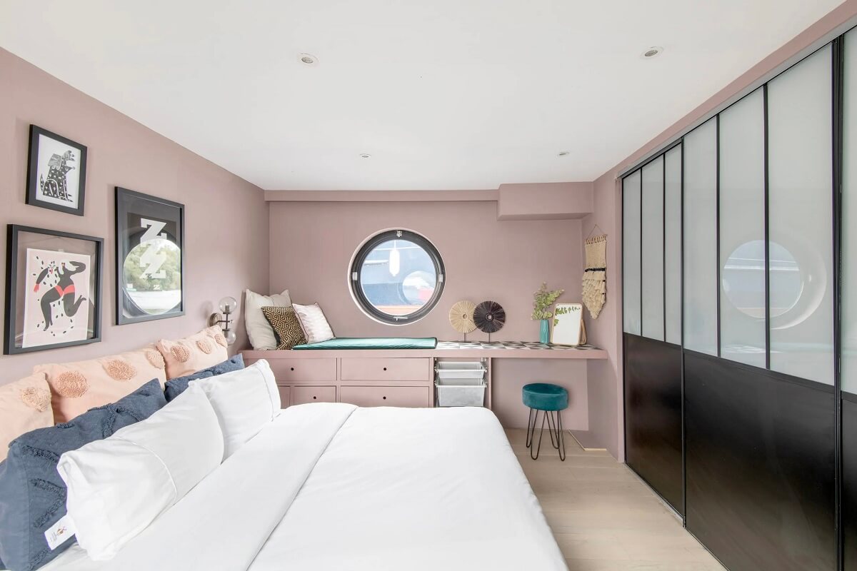 A Spacious and Stylish Houseboat in London 8 pink bedroom window seat industrial steel doors houseoat nordroom