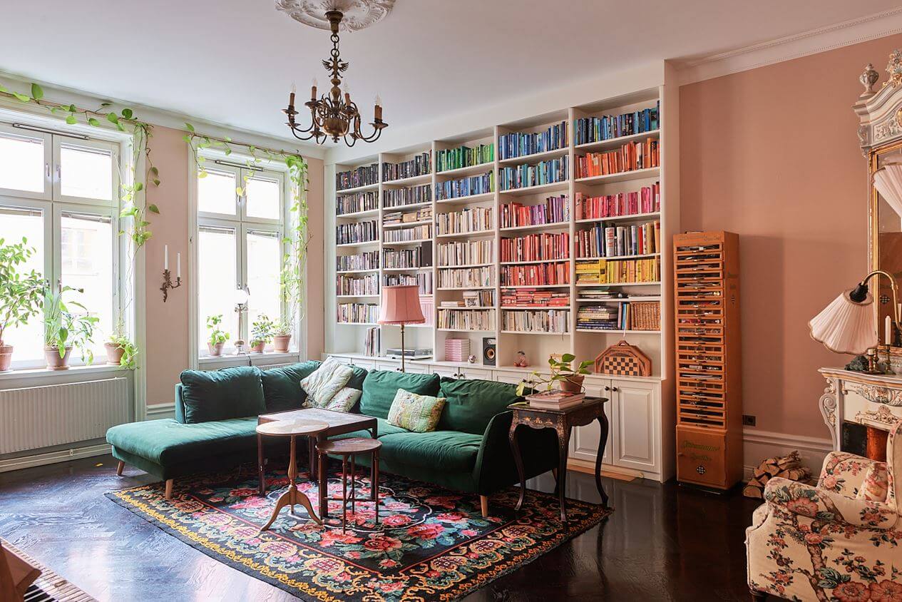 A Romantic Apartment with Original Details 2 pink-living-room-floral-rug-green-sofa-bookshelves-nordroom