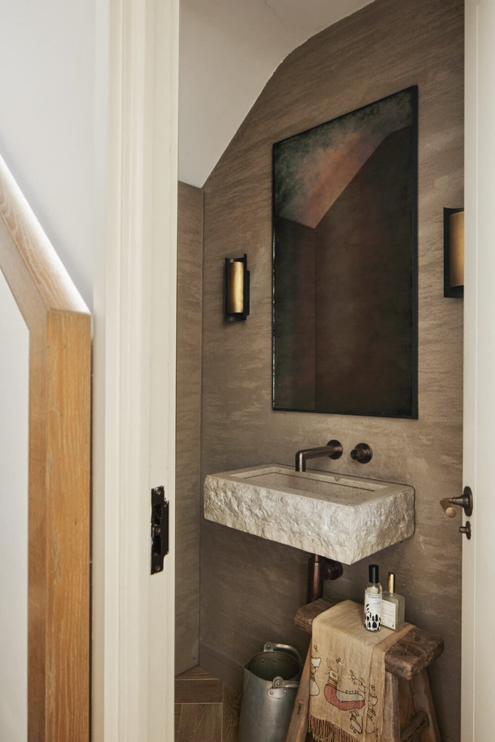 Stylish Monochrome Interiors in an Early 20th Century House 15 powder-room-raw-cut-stone-sink-nordroom