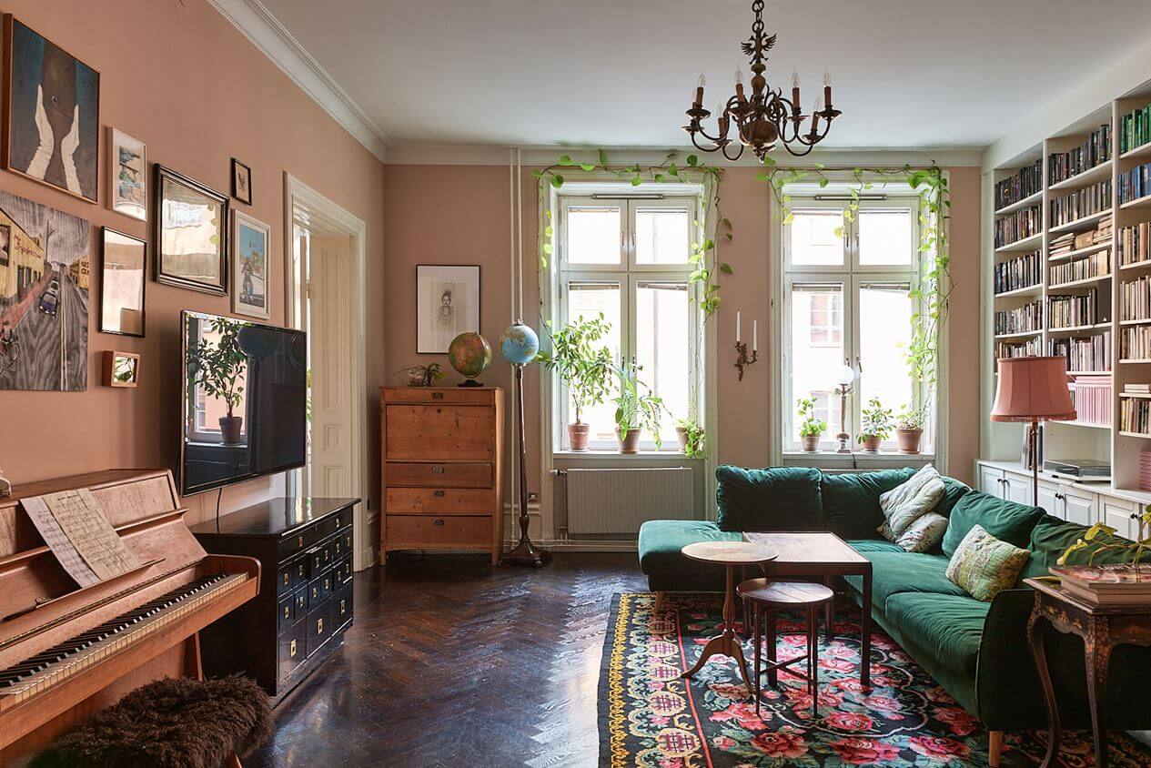 A Romantic Apartment with Original Details 4 romantic-living-room-pink-walls-green-sofa-bookshelves-nordroom