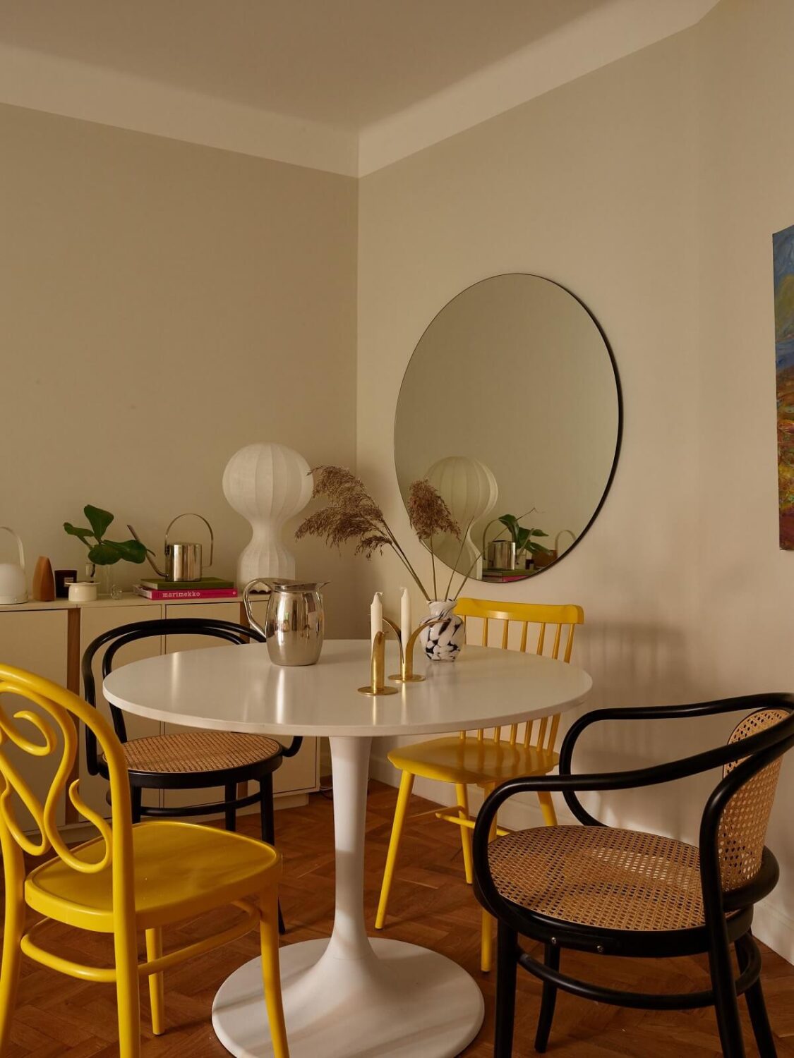A Serene Light Colored Apartment with Bright Color Pops 11 round dining table mirror living room beige walls