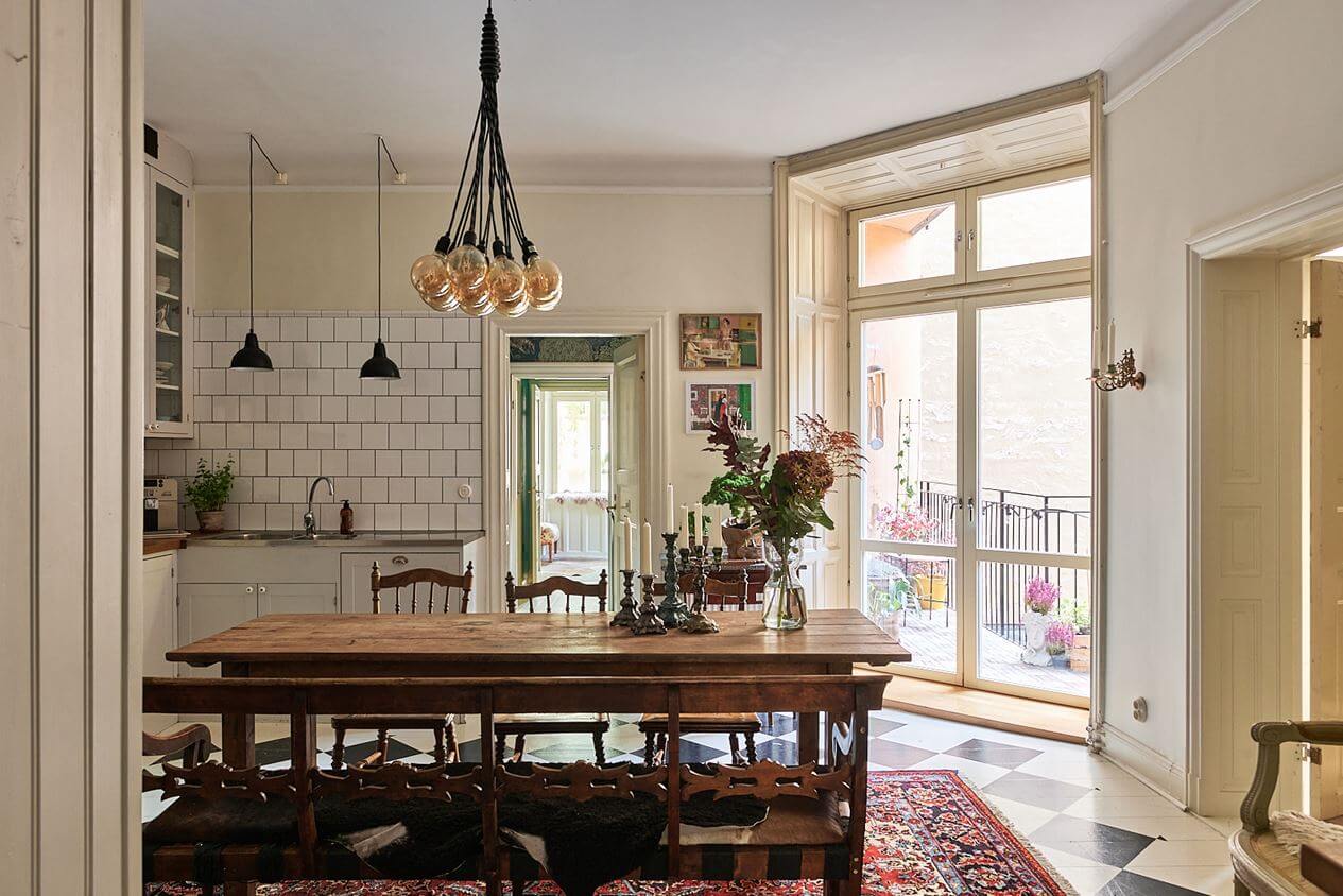 A Romantic Apartment with Original Details 15 rustic-wooden-dining-table-kitchen-checkerboard-floor