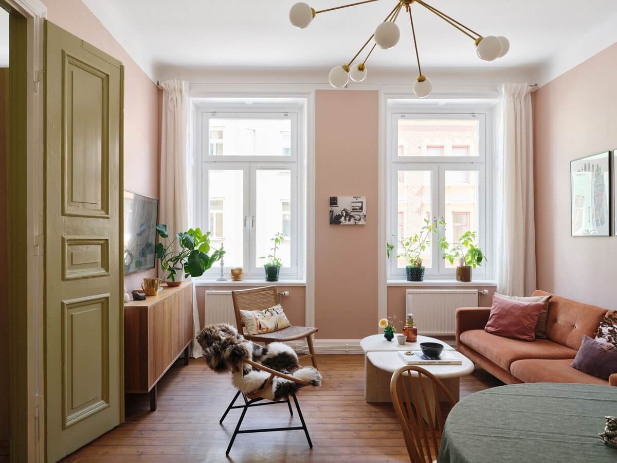 A Scandi Apartment Mixes Vintage with Contemporary Design 1 scandinavian-living-room-light-pink-walls-green-doors-nordroom