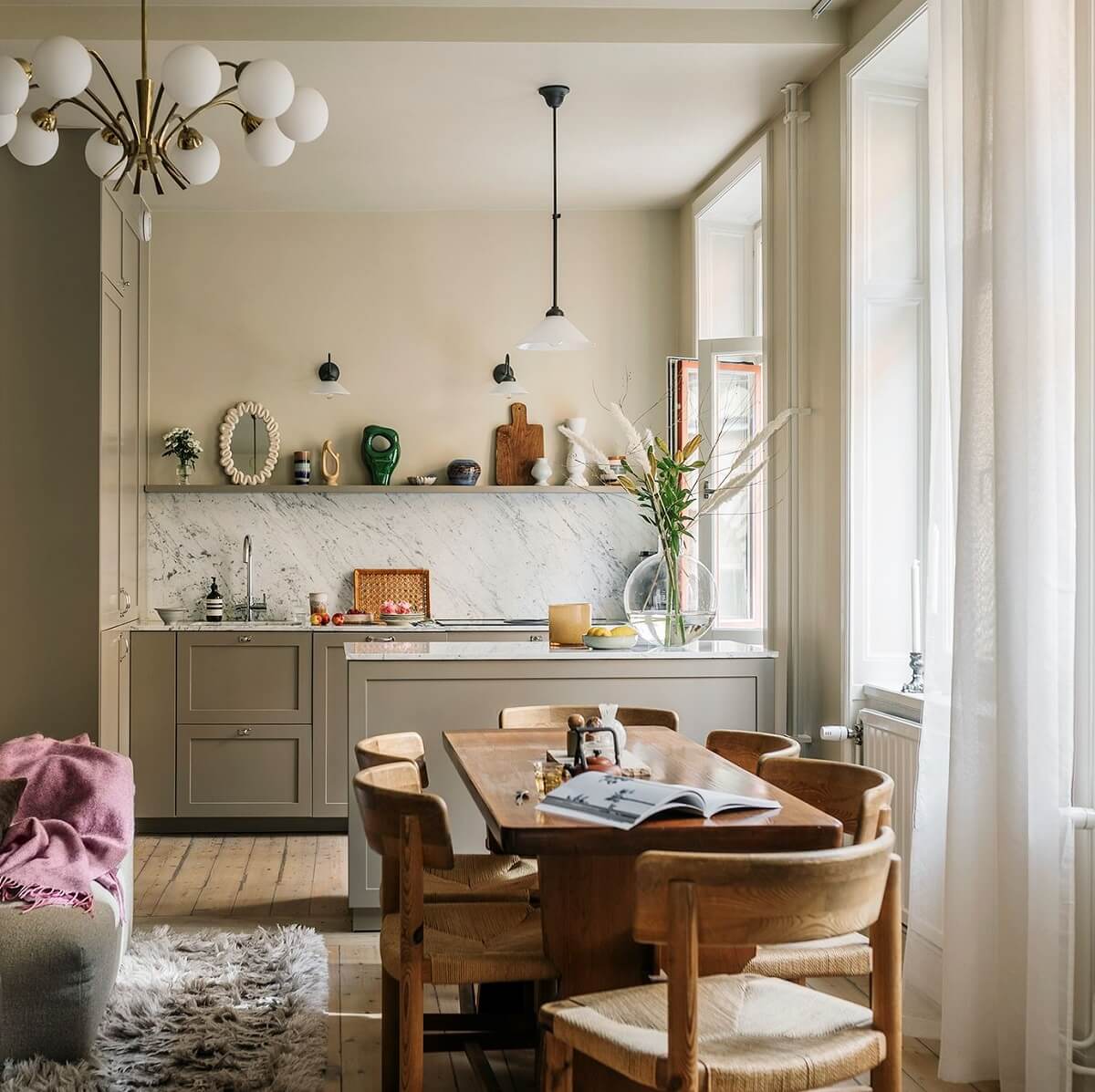 A Cozy Scandinavian Apartment with a Cobalt Color Accent 1 scandinavian living space with wooden dining table and open kitchen