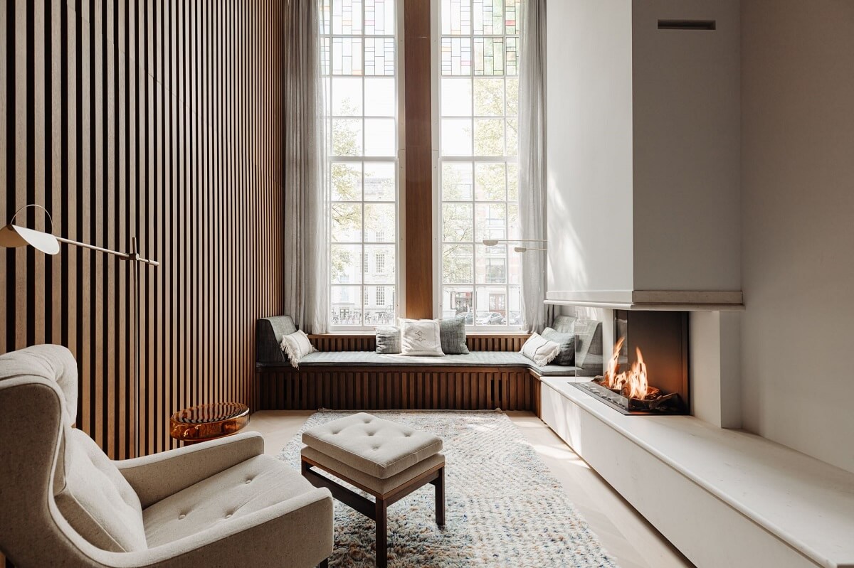 A Luxurious Amsterdam Canal House with High Ceilings 4 seating room with window seat and fireplace