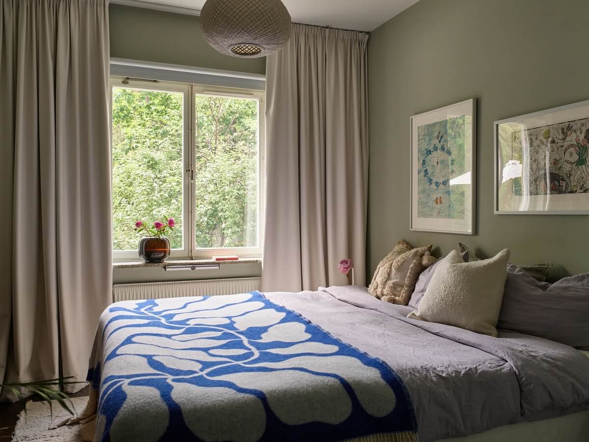 Soft Yellow Walls in a Swedish Apartment 14 serene-bedroom-olive-green-feature-wall-nordroom