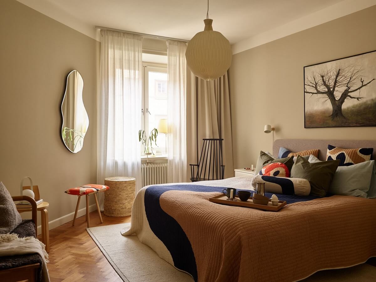 A Serene Light Colored Apartment with Bright Color Pops 15 serene scandinavian bedroom colorful bedding