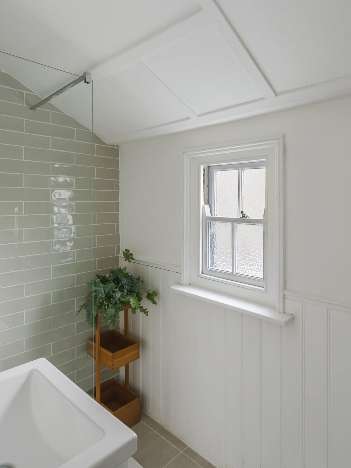 A Light Coastal Home in England 18 small bathroom white walls light gray tiles