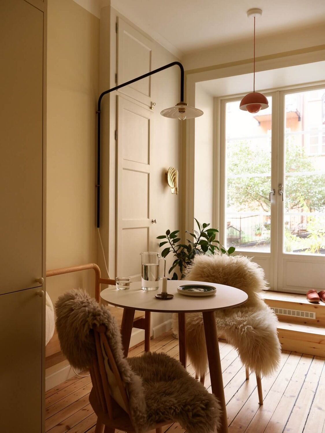 A Serene Light Colored Apartment with Bright Color Pops 2 small kitchen table wooden floor