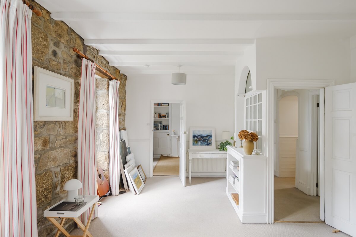 A Light Coastal Home in England 3 stone accent wall coastal living room
