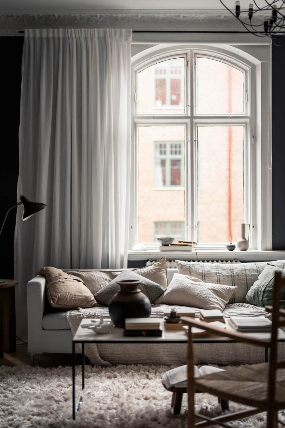 A Scandinavian Studio Apartment with Black Walls 2 studio apartment high ceilings large windows white furnishings