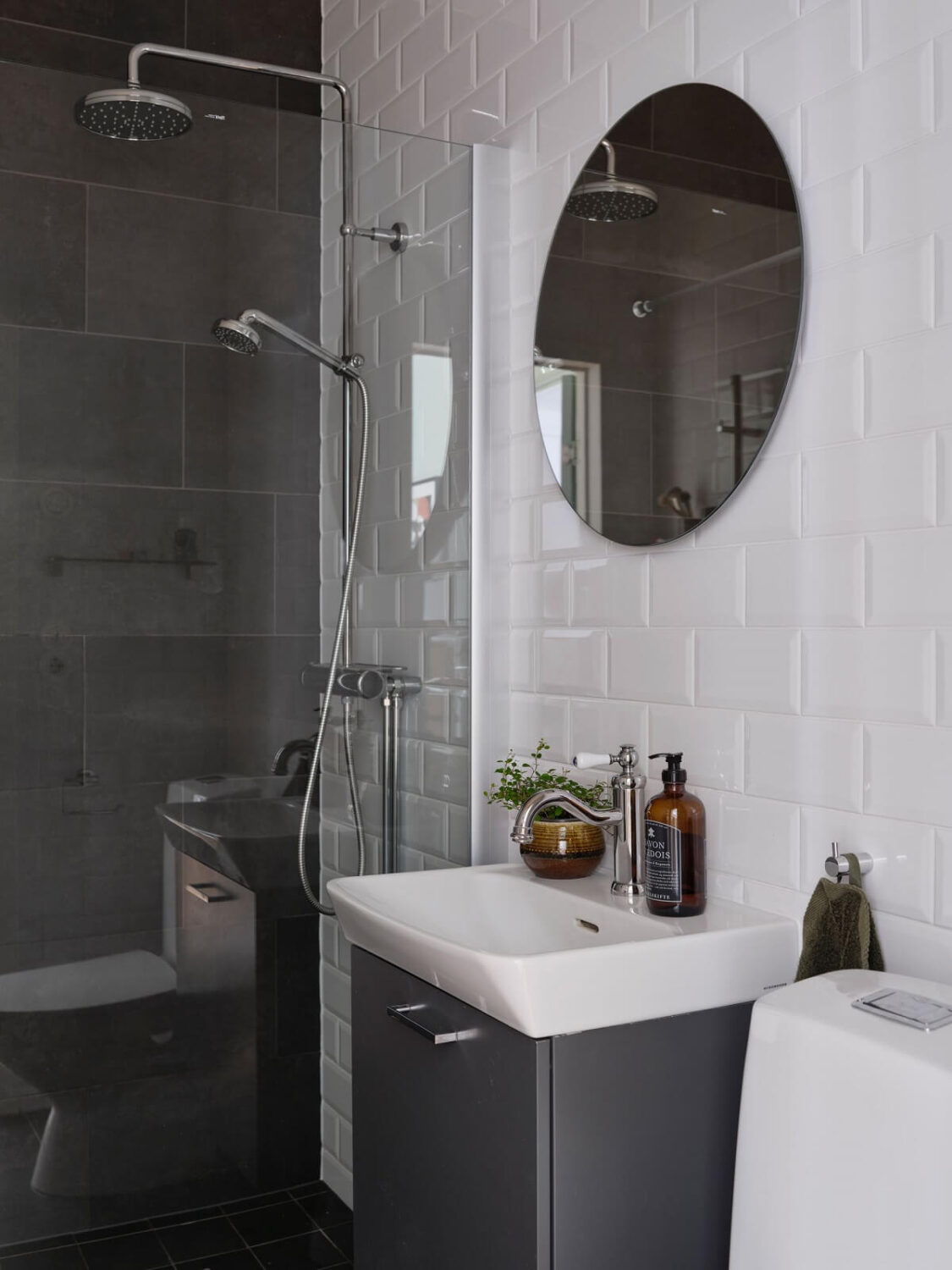 A Scandi Apartment Mixes Vintage with Contemporary Design 24 tiny-bathroom-gray-tiles-round-mirror-nordroom