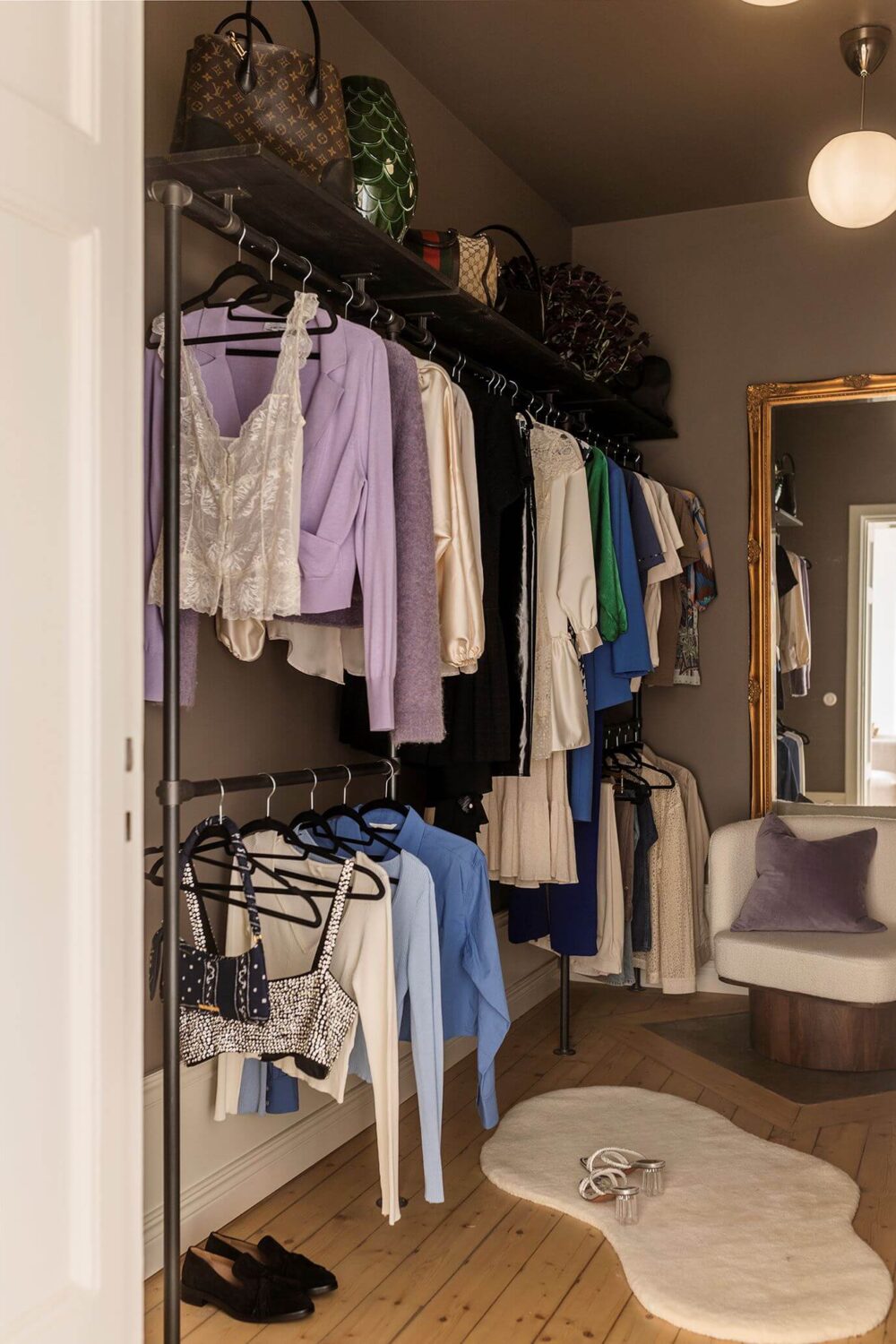 A Cozy Scandinavian Apartment with a Cobalt Color Accent 17 walk in closet with open hanging racks