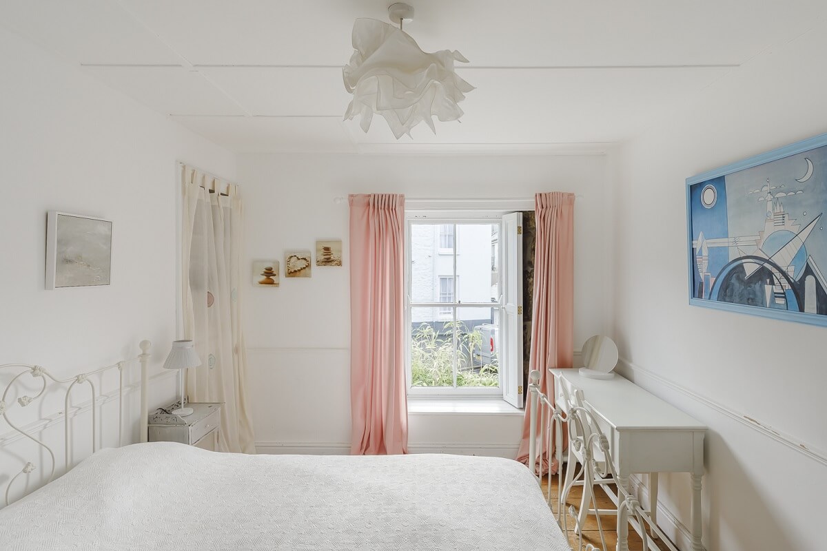 A Light Coastal Home in England 15 white coastal bedroom pink curtains