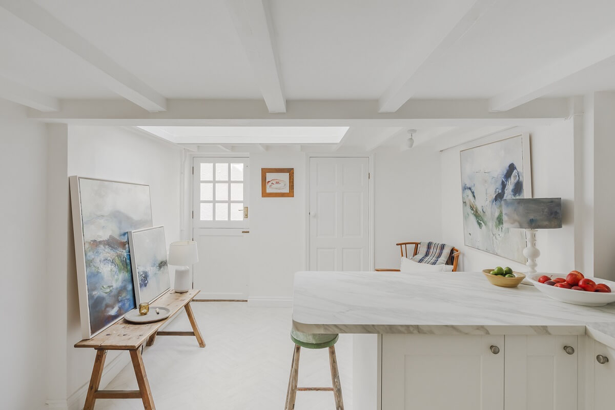A Light Coastal Home in England 8 white coastal kitchen skylight low ceiling