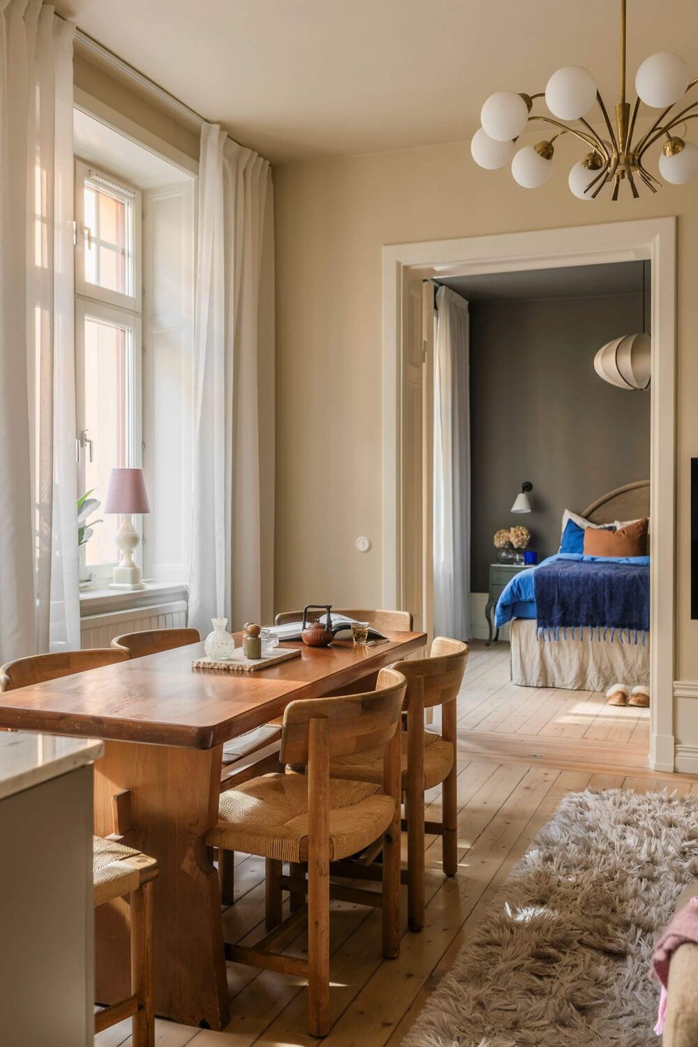 A Cozy Scandinavian Apartment with a Cobalt Color Accent 12 wooden dining table scandinavian living room