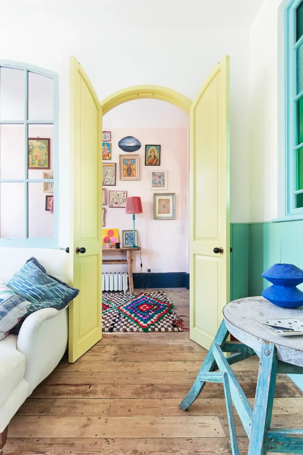A Playful Colorful Eclectic Artist Home in London 16 yellow arched doors wooden floor sitting room nordroom