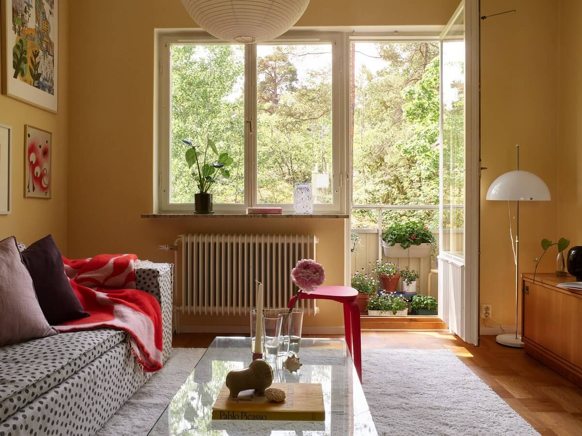 Soft Yellow Walls in a Swedish Apartment 3 yellow-living-room-red-accents-nordorom