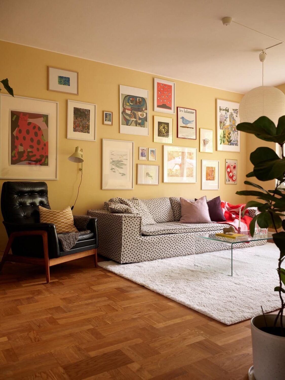 Color of the Year 2025 Prediction (with Color Palettes) 23 yellow-walls-living-room-wooden-floor-polkadot-sofa-nordroom