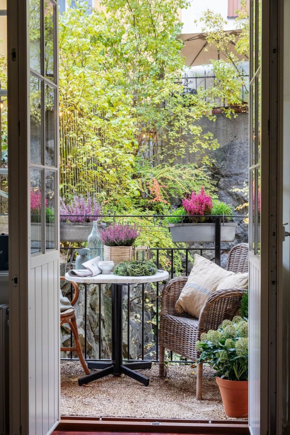 A Cozy Swedish Apartment with a Green Kitchen 26 balcony with bistro seating