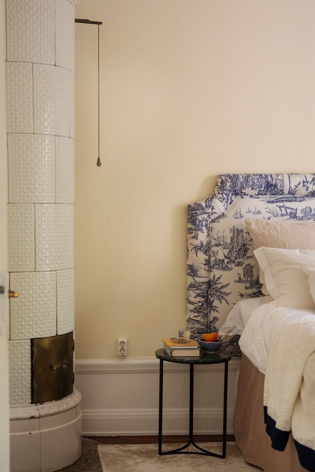 A Cozy Swedish Apartment with a Green Kitchen 25 beige headboard fireplace headboard detail