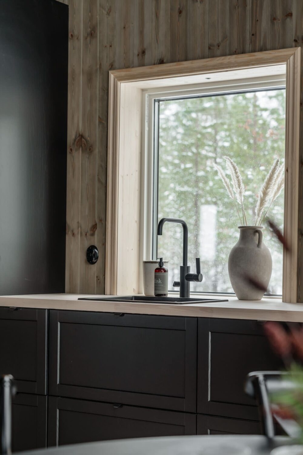 A Cozy Log House in Sweden 12 black-kitchen-cabinets