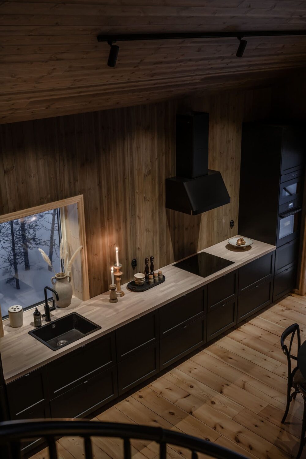 A Cozy Log House in Sweden 5 black-kitchen-wooden-walls-log-house-at-night-nordroom
