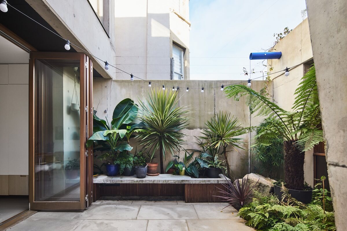 A Modern House Centered Around a Courtyard 12 concrete-courtyard-garden-plants-nordroom