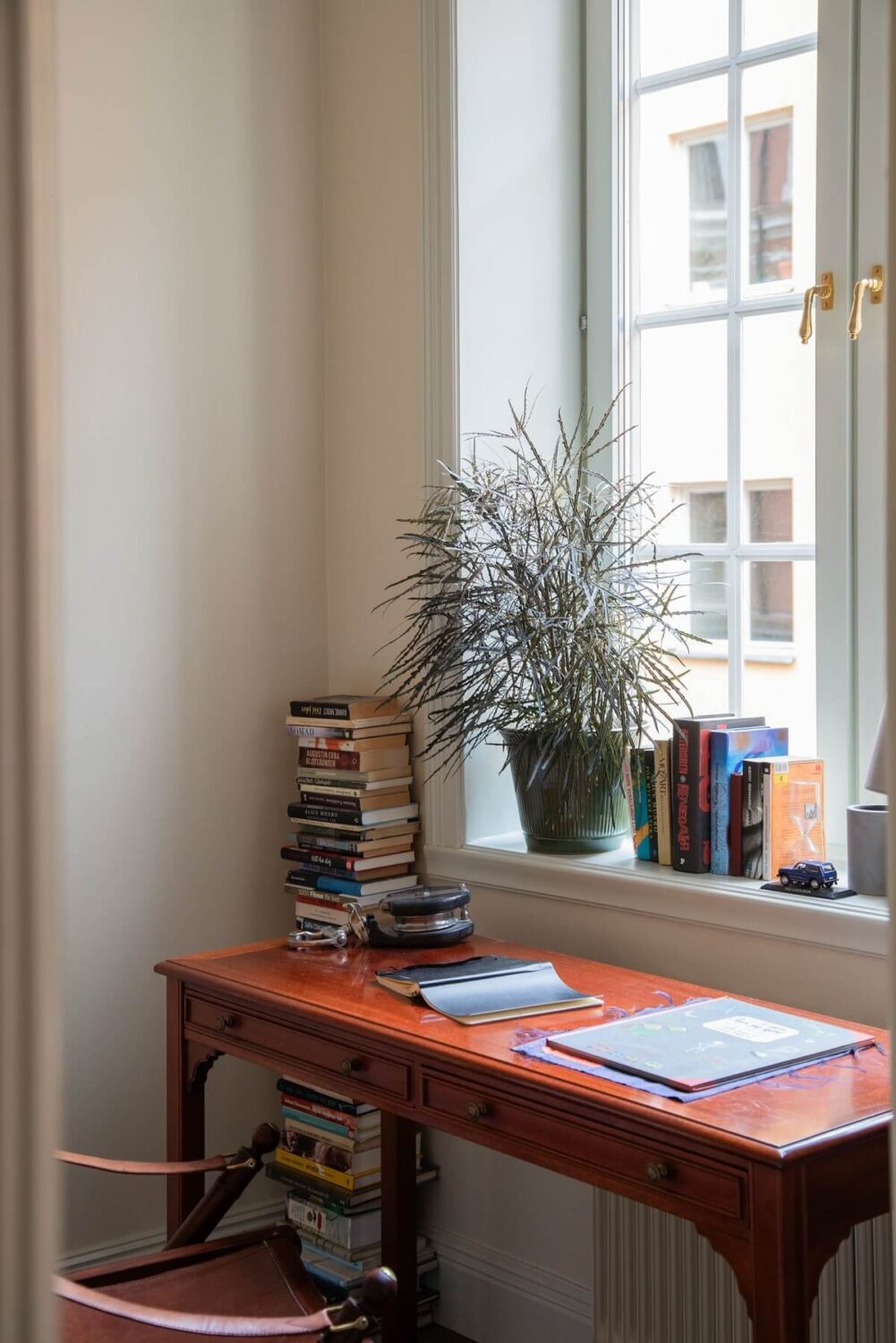 A Cozy Swedish Apartment with a Green Kitchen 20 desk under window in tiny bedroom