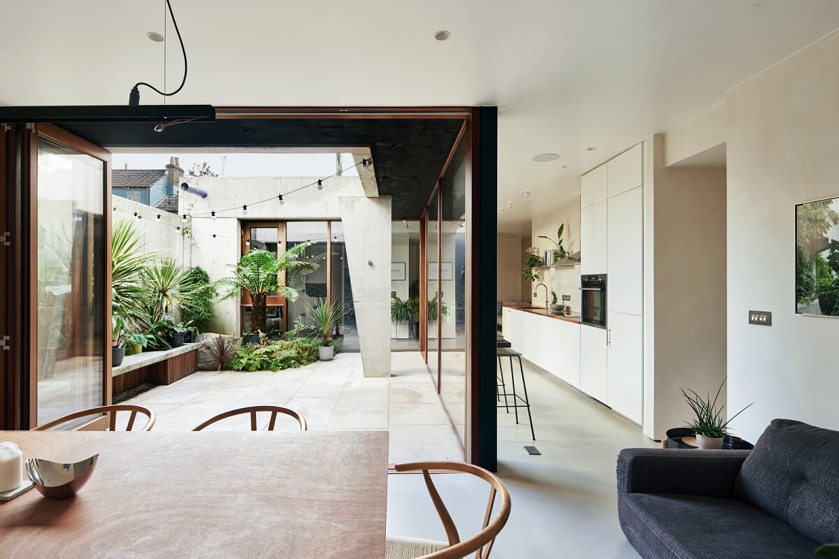 A Modern House Centered Around a Courtyard 8 dining-room-glass-doors-courtyard-garden-nordroom