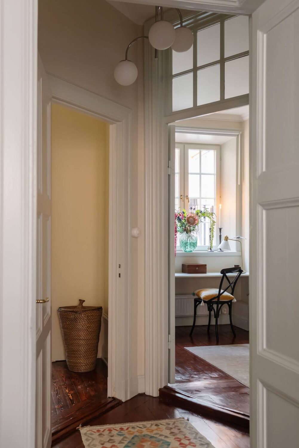A Cozy Swedish Apartment with a Green Kitchen 21 hallway mahogany stained floorboards